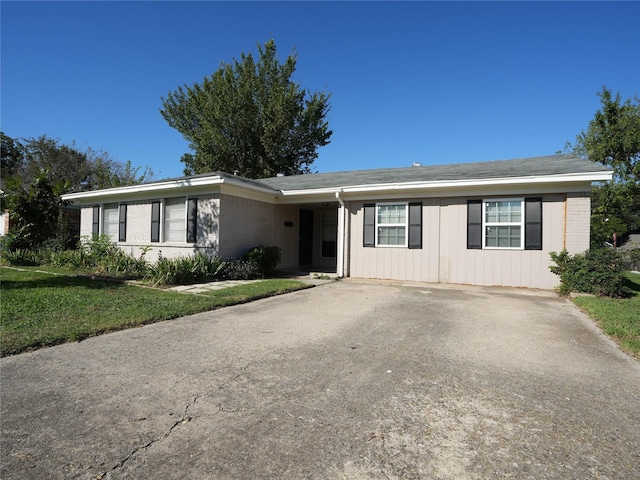 ranch-style house with a front lawn