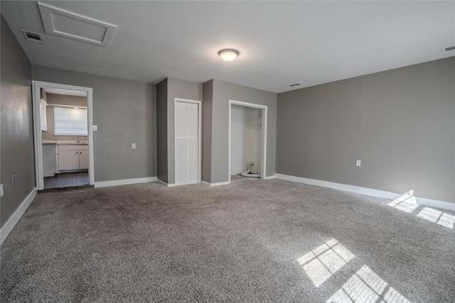 unfurnished bedroom featuring carpet flooring and connected bathroom