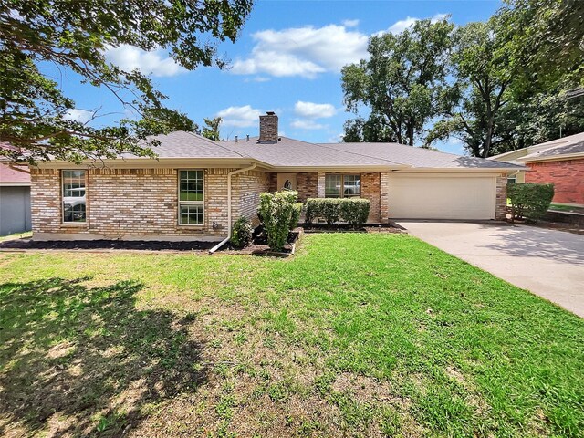 single story home featuring a garage and a front lawn