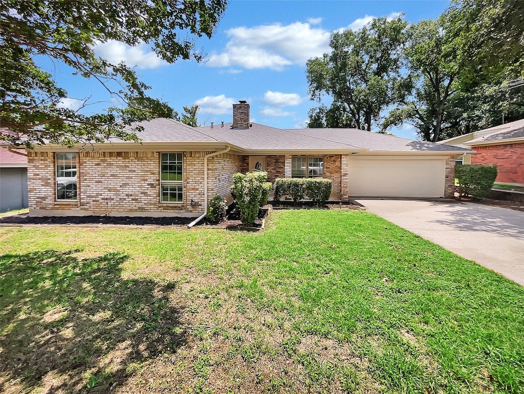 ranch-style house featuring a garage and a front yard