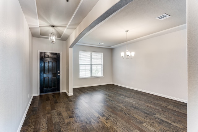 entrance foyer with dark hardwood / wood-style flooring and an inviting chandelier