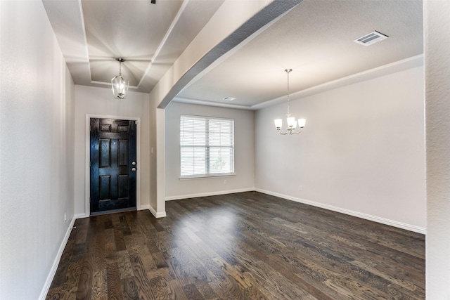 entryway with dark hardwood / wood-style flooring and a chandelier