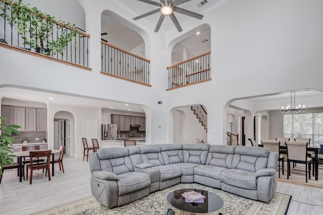 living room with ornamental molding and light hardwood / wood-style flooring