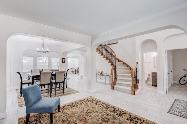 entryway featuring an inviting chandelier and ornamental molding