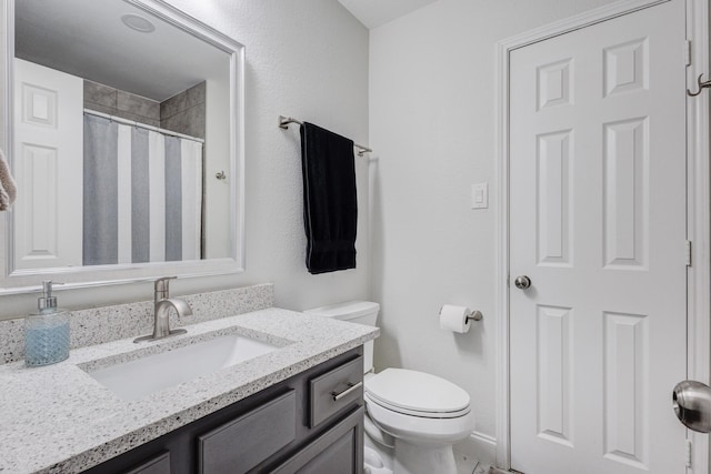 bathroom with vanity, toilet, and walk in shower