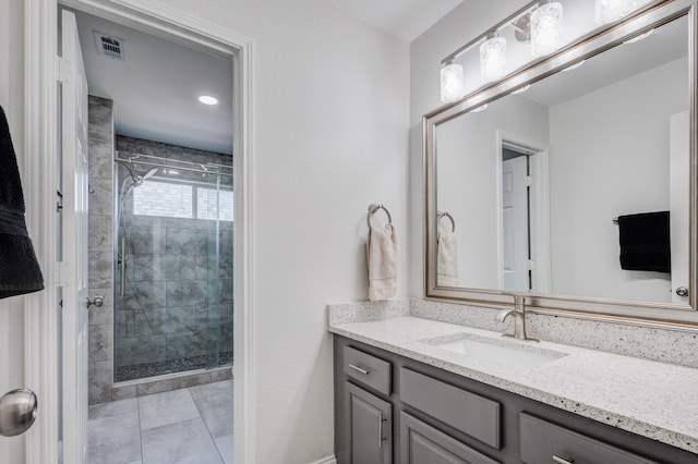 bathroom featuring vanity, tile patterned flooring, and a shower with door