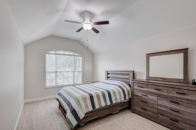 carpeted bedroom featuring ceiling fan and vaulted ceiling