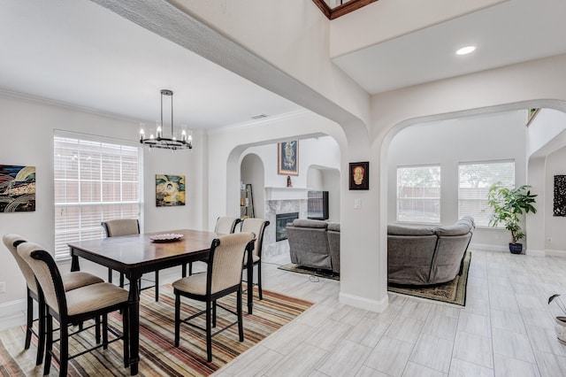 dining room with crown molding and a chandelier