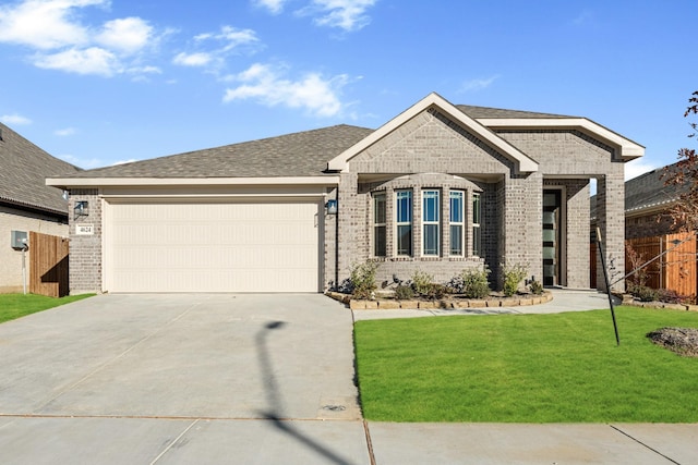 view of front facade featuring a front yard and a garage