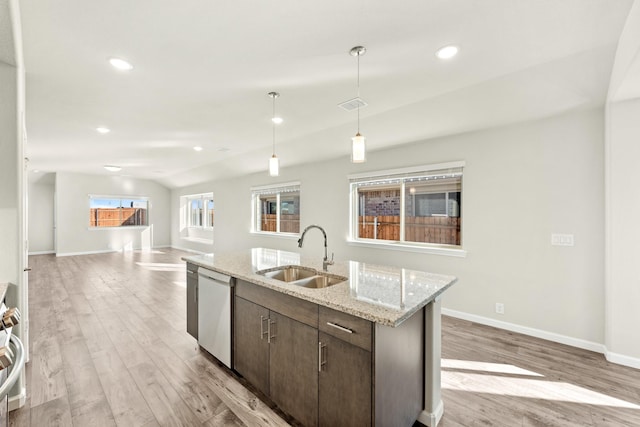 kitchen with sink, stainless steel appliances, light hardwood / wood-style flooring, a center island with sink, and dark brown cabinets