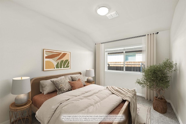 bedroom featuring lofted ceiling and carpet floors