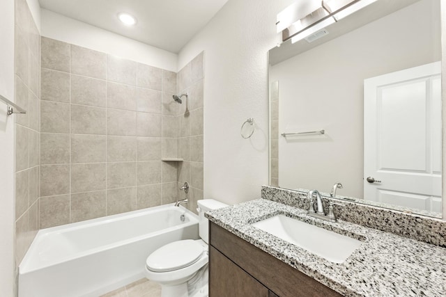 full bathroom featuring vanity, tiled shower / bath combo, and toilet