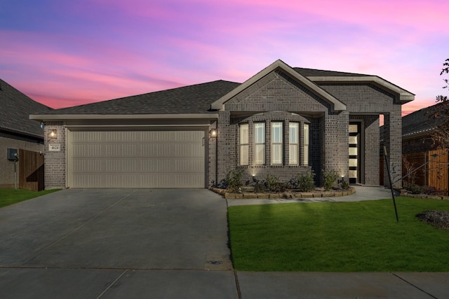 view of front of house with a yard and a garage