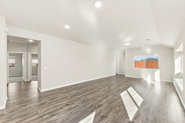 unfurnished living room featuring lofted ceiling and hardwood / wood-style flooring