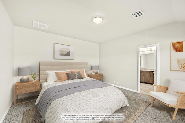 carpeted bedroom featuring connected bathroom and vaulted ceiling