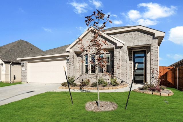 view of front of house featuring a garage and a front yard