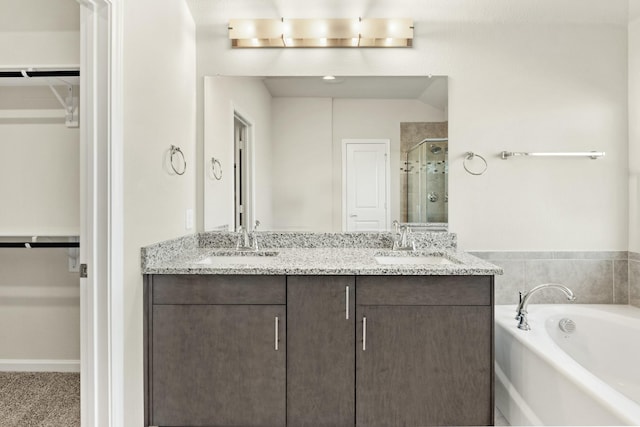 bathroom featuring shower with separate bathtub and vanity