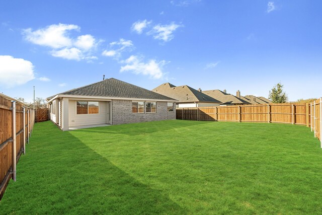 rear view of house featuring a lawn