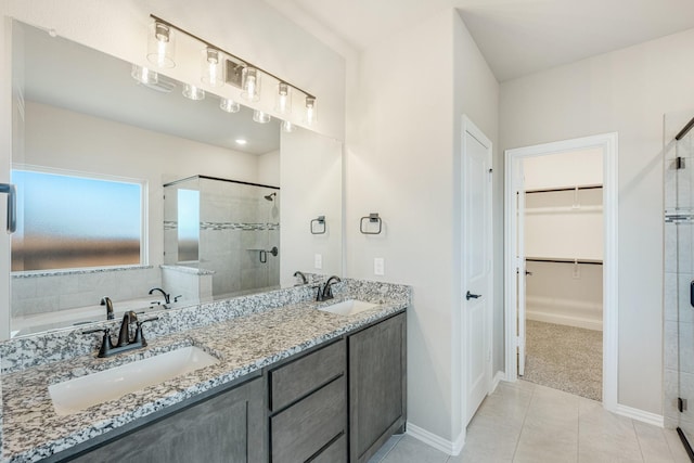 bathroom featuring tile patterned flooring, vanity, and shower with separate bathtub