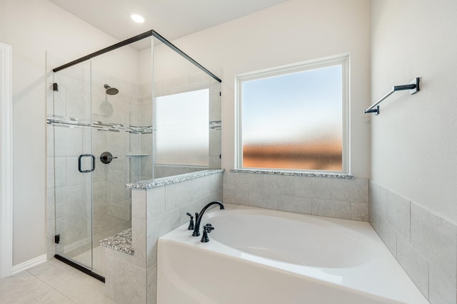 bathroom featuring tile patterned flooring and independent shower and bath