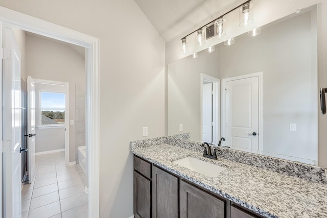 bathroom featuring tile patterned flooring, vanity, and vaulted ceiling