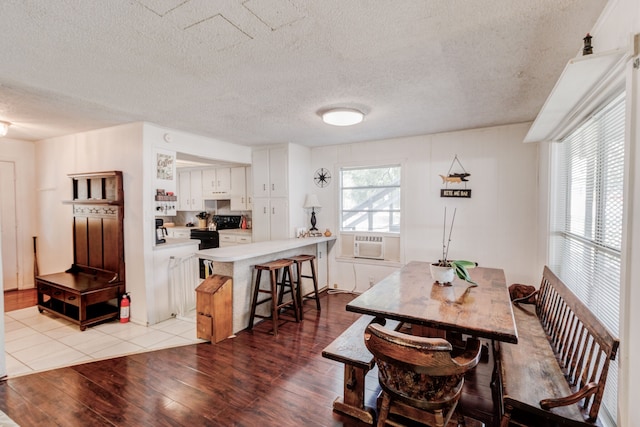 tiled dining space featuring a textured ceiling