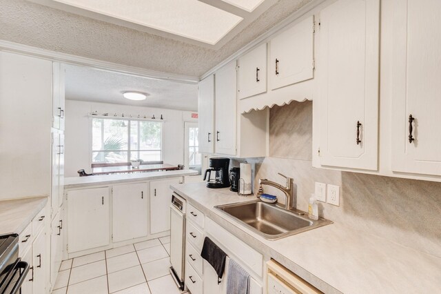 kitchen with a wealth of natural light, white cabinetry, backsplash, and black electric range