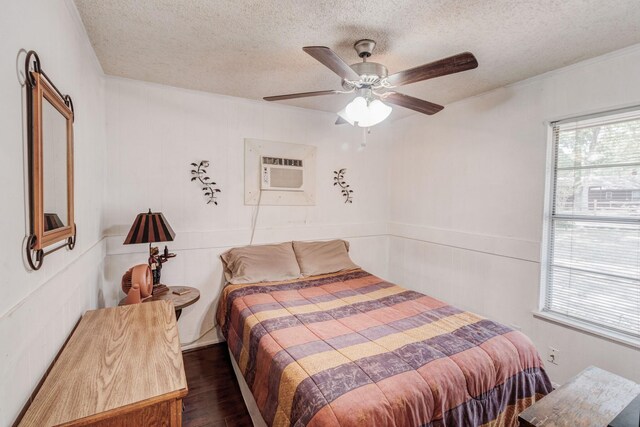 tiled foyer entrance featuring a wall mounted air conditioner, a textured ceiling, and crown molding