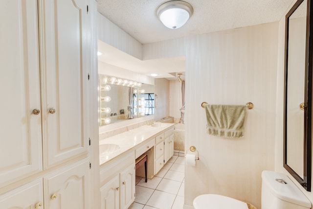 bathroom with double vanity, tile flooring, toilet, and a textured ceiling