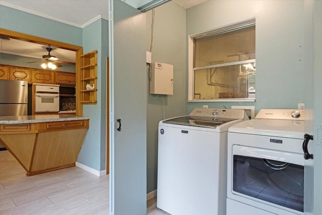 clothes washing area with washer and dryer, ceiling fan, and crown molding