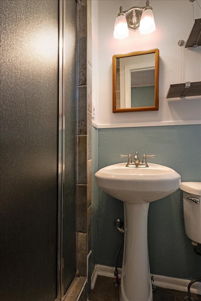 bathroom with toilet and walk in shower