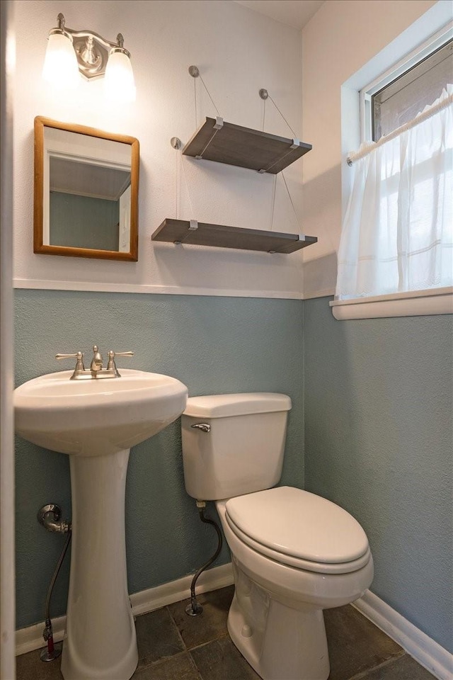 bathroom with sink, tile patterned flooring, and toilet