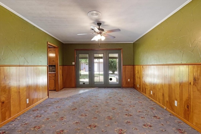 empty room with ceiling fan, french doors, and crown molding