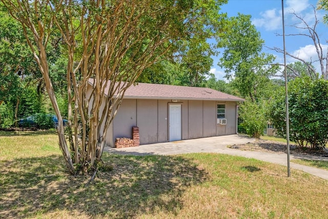 view of outbuilding with a yard and cooling unit