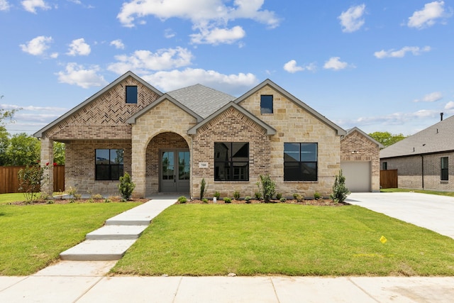 view of front of home with french doors and a front lawn