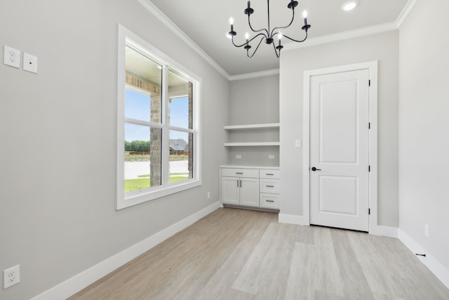 interior space with built in shelves, light hardwood / wood-style floors, crown molding, and a chandelier