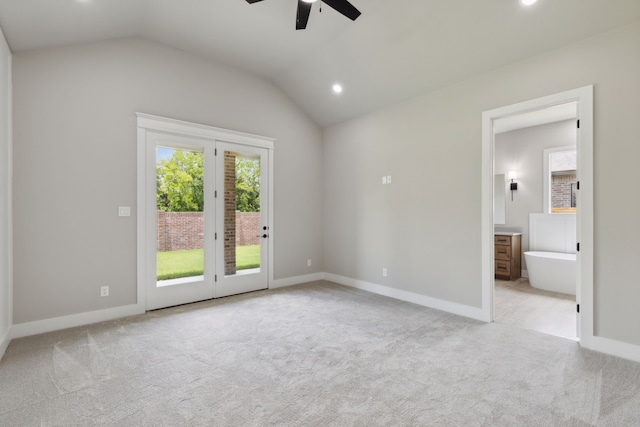 carpeted empty room with ceiling fan and vaulted ceiling