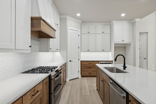 kitchen featuring decorative backsplash, sink, white cabinetry, and stainless steel appliances