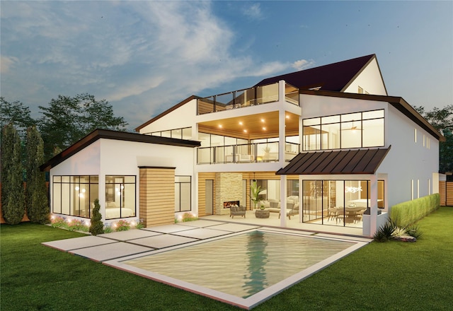 back house at dusk with a lawn, a balcony, an outdoor hangout area, and a patio