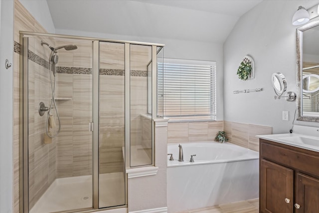 bathroom with vanity, lofted ceiling, and separate shower and tub