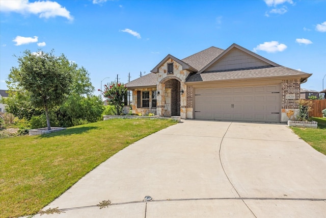 view of front of property with a garage and a front lawn