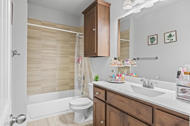 full bathroom featuring vanity, tiled shower / bath, and toilet