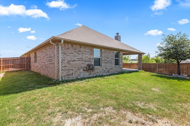 rear view of property with a lawn