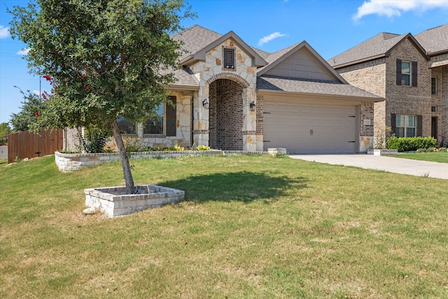 view of front of home with a garage and a front lawn