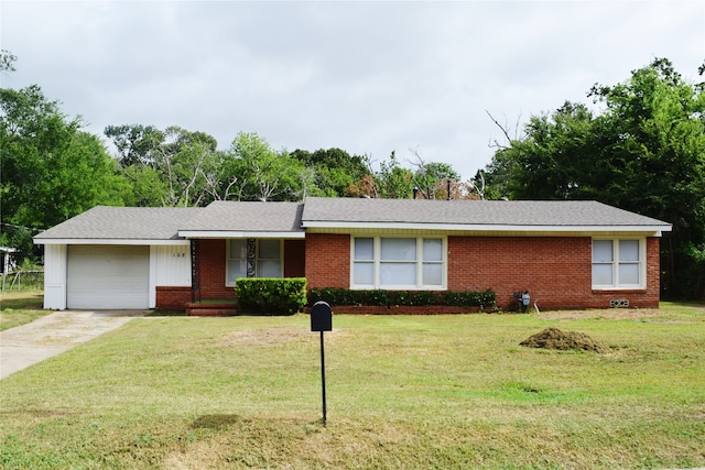 ranch-style home featuring a garage and a front lawn