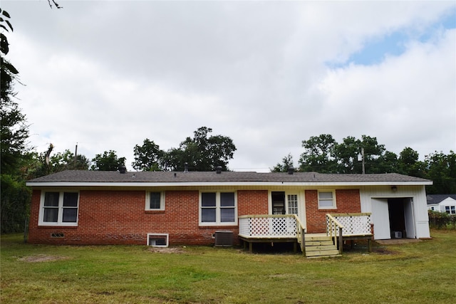 back of house with central AC and a yard