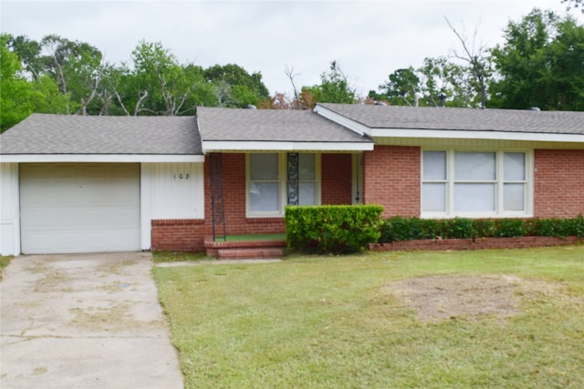 ranch-style home featuring a garage and a front yard