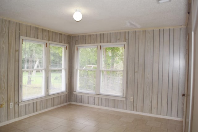 108 W Clinton Ave, Athens, TX 75751 - empty room with baseboards, wooden walls, and a textured ceiling