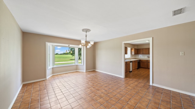 tiled spare room featuring an inviting chandelier and sink