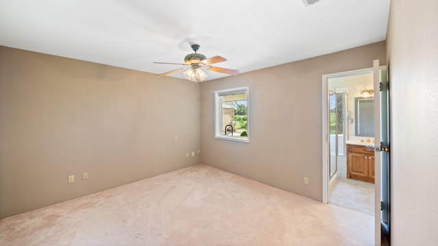 carpeted empty room featuring ceiling fan